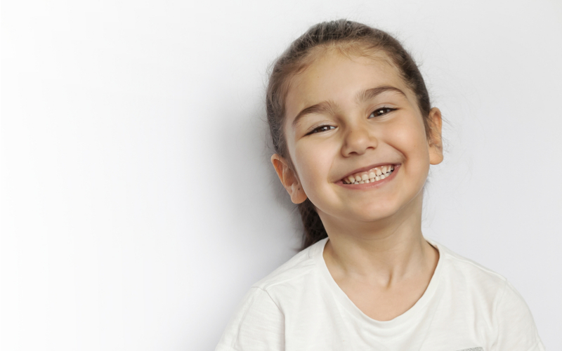 little girl smiling on white background